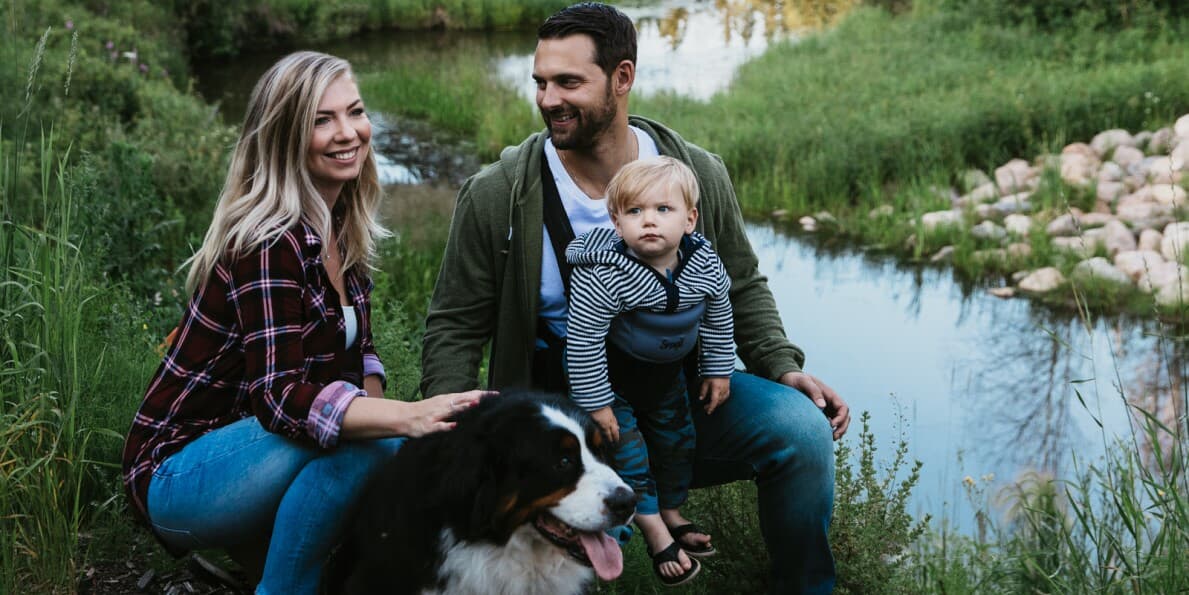 Family with their dog by a river in Edmonton, AB