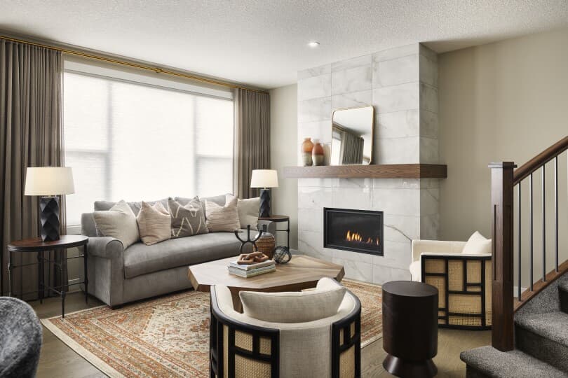 Living area with fireplace in Robson 2 at Livingston by Brookfield Residential in Calgary, AB