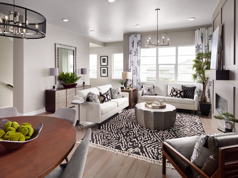 Family room with fireplace and white couches in Cadence 6 at Midtown in Denver, CO