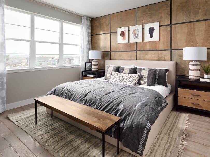Primary bedroom with wood feature wall at Cadence 6 at Midtown in Denver, CO
