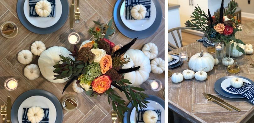 Floral arrangement on a table with white pumpkins and candles