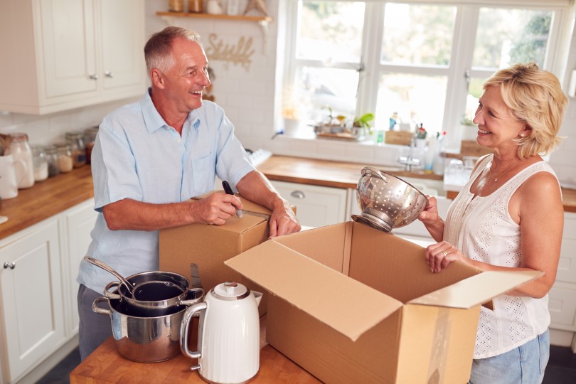 Older couple packing and organizing their kitchen goods