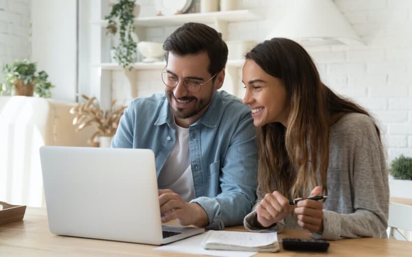 Young couple homeshopping on a laptop