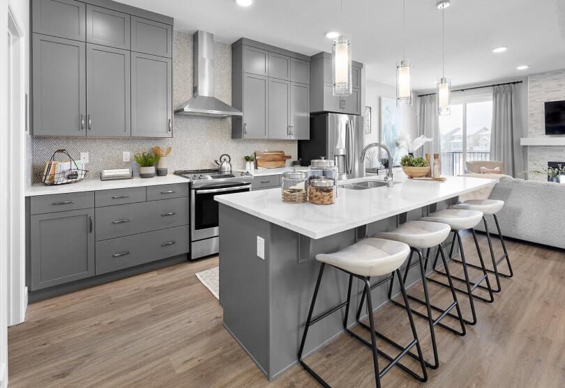 Gray kitchen with island in Hudson at Chappelle Gardens by Brookfield Residential in Edmonton, AB