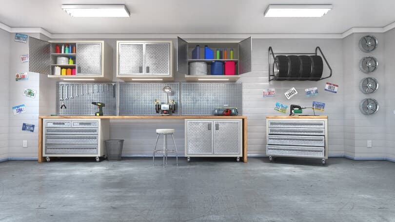 Organized garage storage with cabinets and a workbench
