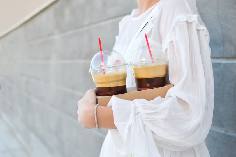 Person with Iced Coffees | New Homes by Brookfield Residential