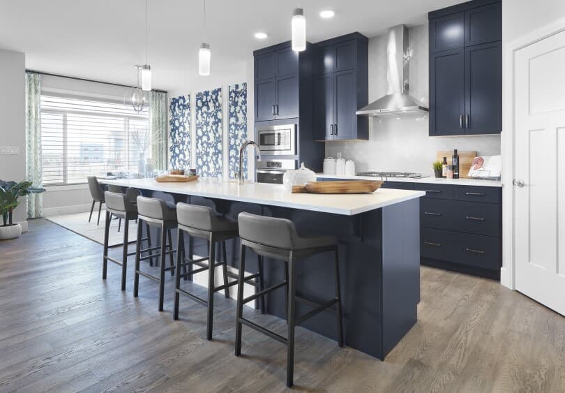 Dark blue kitchen with island in Robson at The Orchards in Edmonton, Alberta