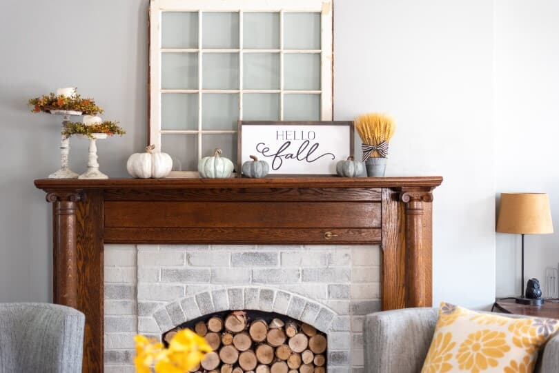 Fall inspired fireplace mantel with pumpkins and foliage