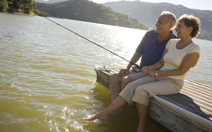 Older couple fishing off the dock in Heritage Shores in Bridgeville, DE by Brookfield Residential