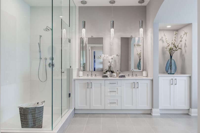 Luxurious white bathroom with glass shower in The Signature Collection at Woodhaven in Aurora, ON