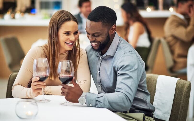 Couple laughing and enjoying red wine