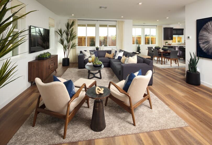 Interior view of the living, dining, and kitchen areas in Residence 6 at Chandler in Brentwood, CA