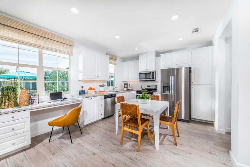 Bright white kitchen and tech space at Lantana@Beach Towns in Stanton, CA by Brookfield Residential