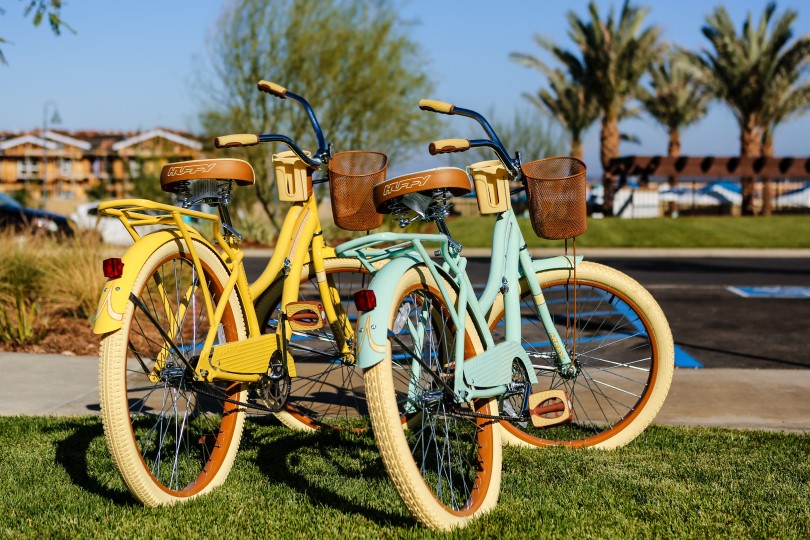 Two beach cruisers parked on the grass