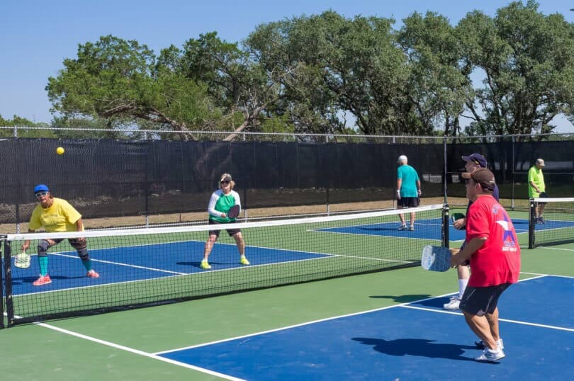 Friends playing a pickleball game at Kissing Tree in San Marcos, TX